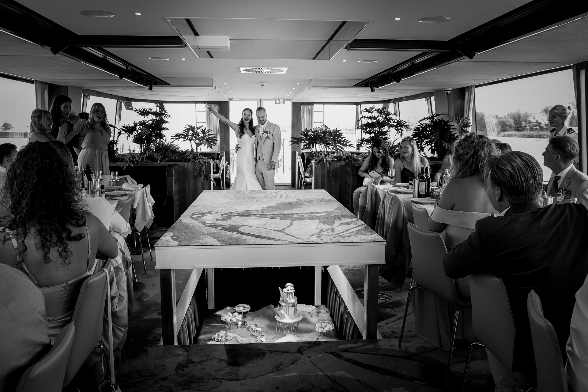 Foto van een bruidspaar waar de sweet table opkomt