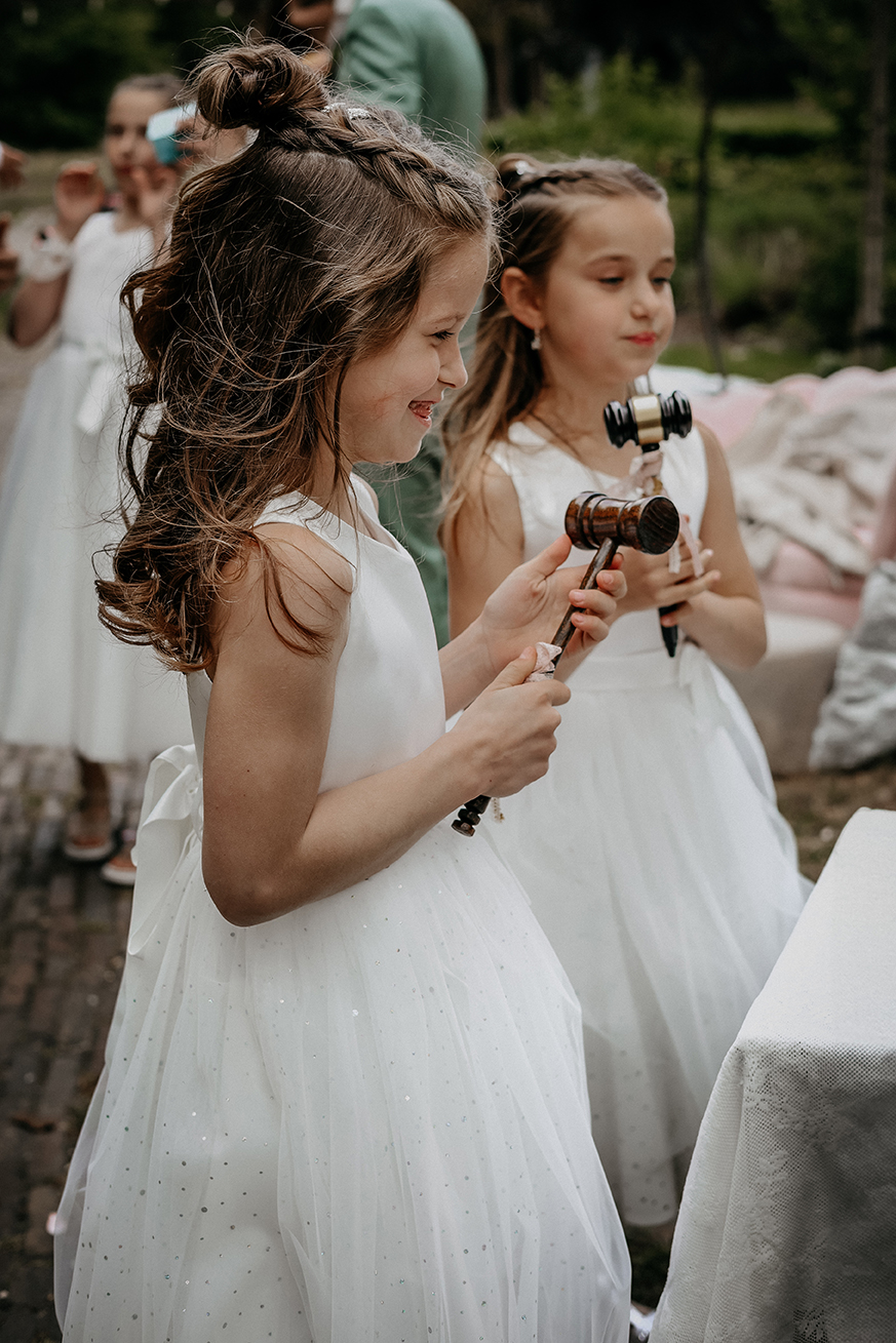 Twee bruidsmeisjes staan klaar met een hamertje tijdens de bruiloft, villa Heidetuin