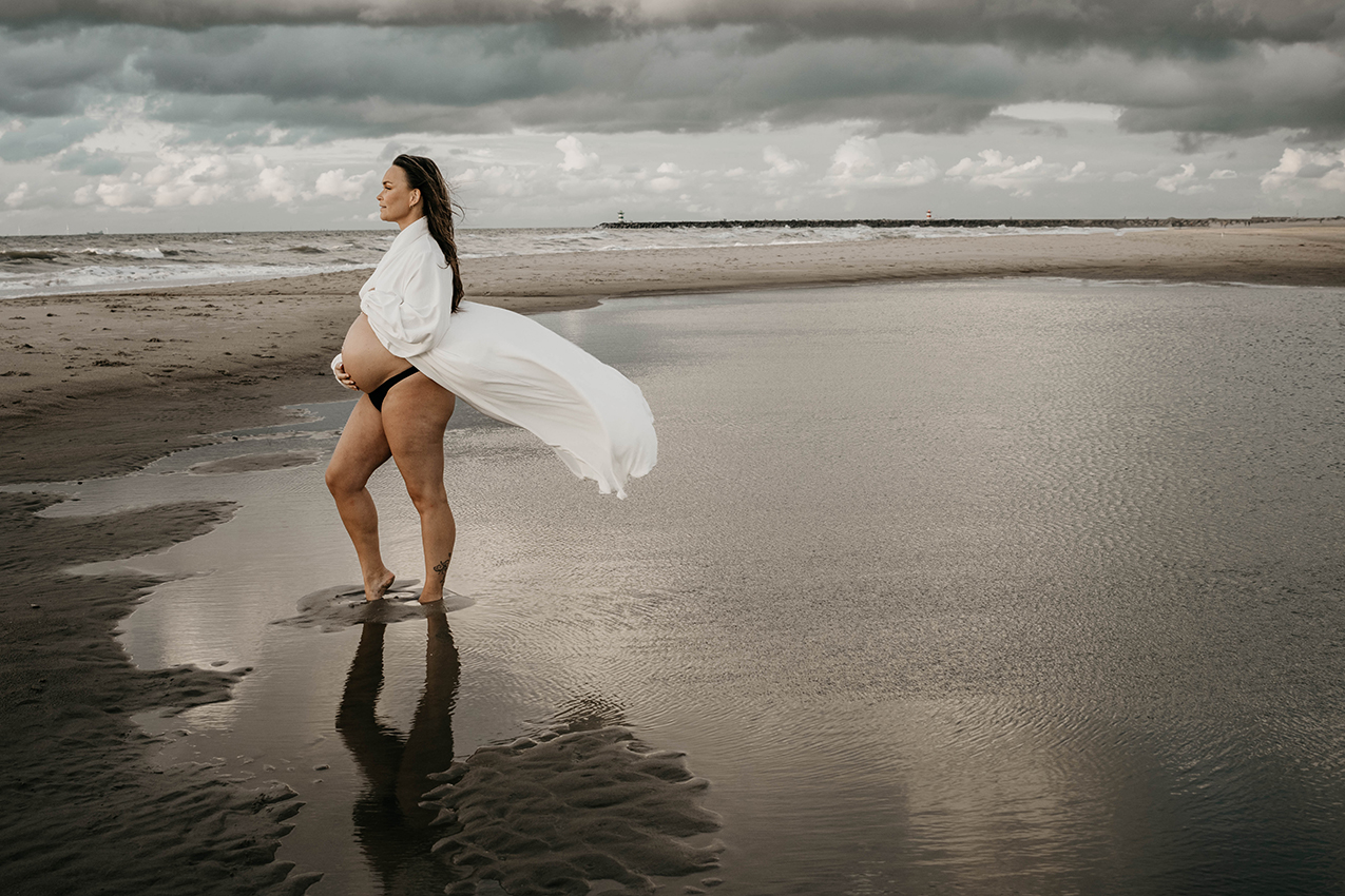 Foto van een zwangere vrouw in de branding, Zoutelande.